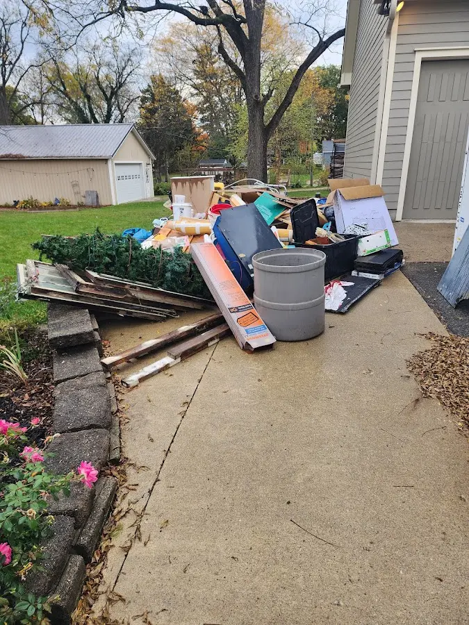 Dumpster being loaded with debris for Roofing Dumpster Rental in Country Club